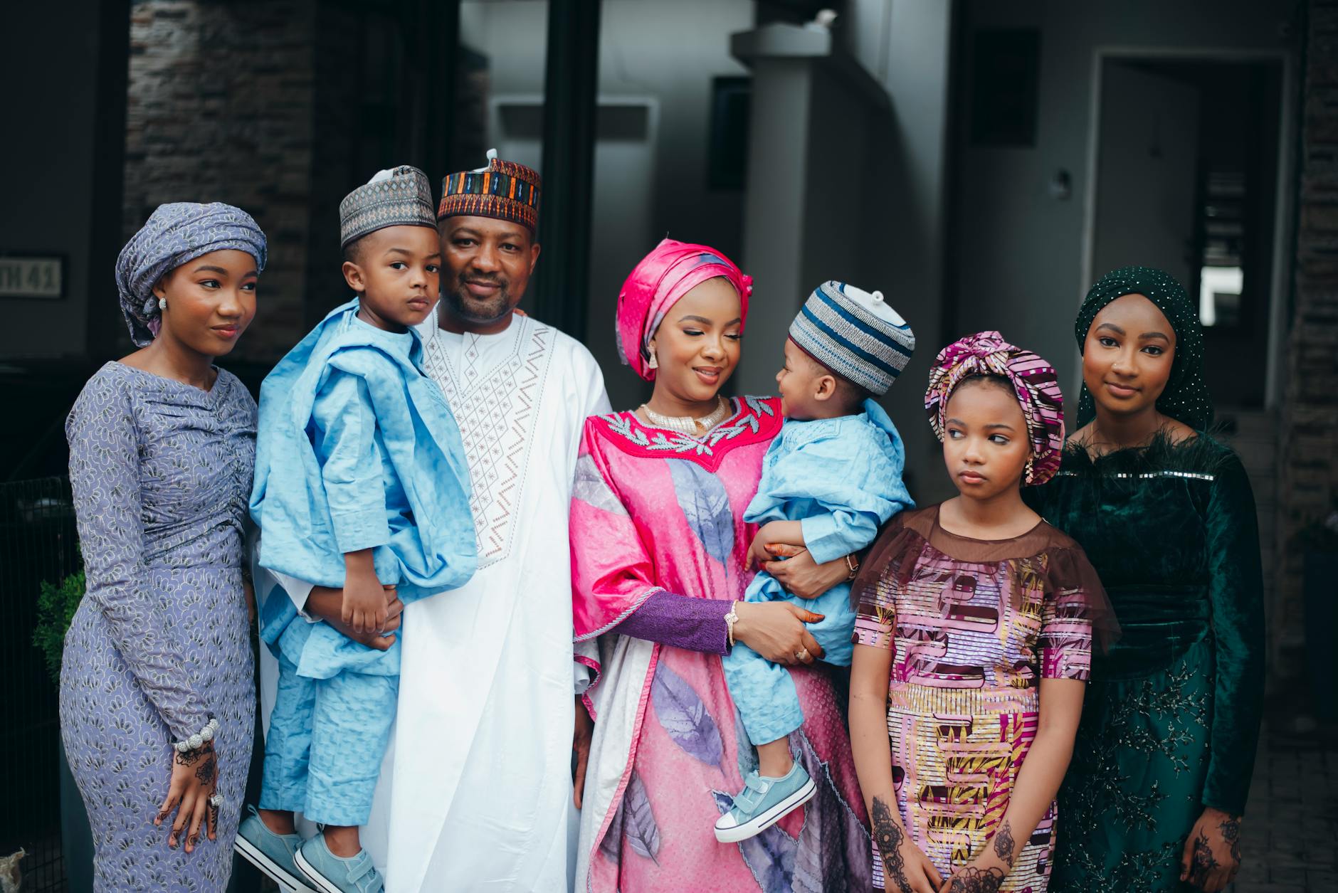 A joyful Nigerian family posing together in vibrant traditional attire, embracing cultural heritage.