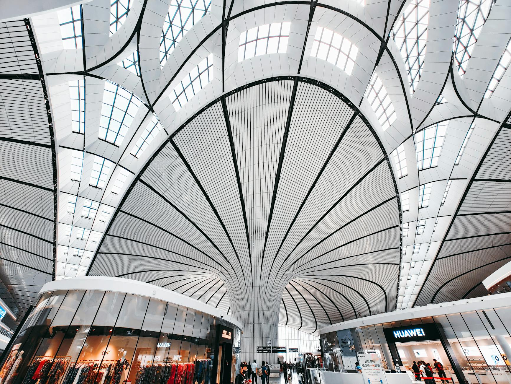 Modern architectural design with curved ceilings in a retail space in Daxing District, Beijing.