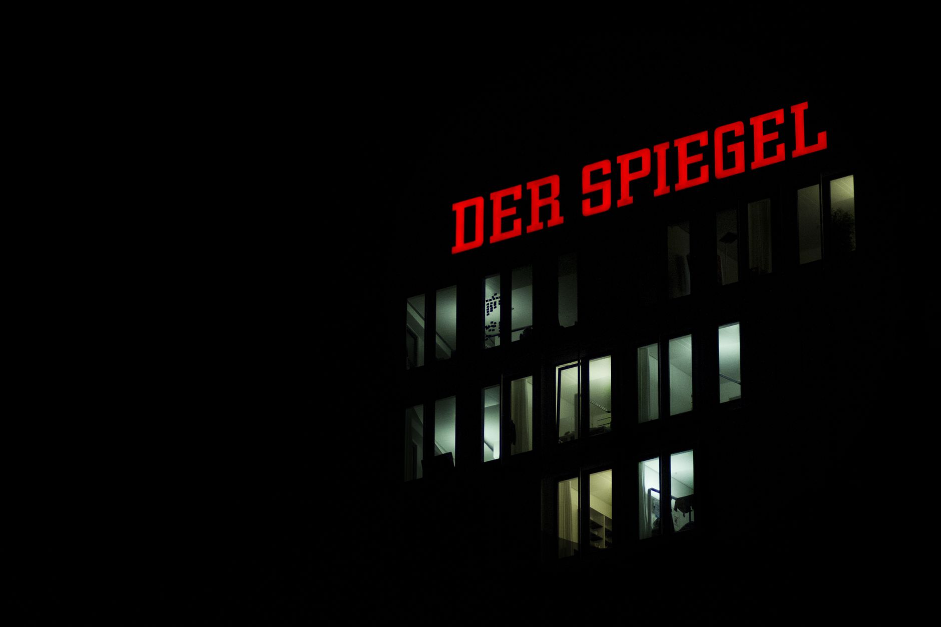 Der Spiegel building facade illuminated at night in Hamburg, Germany.