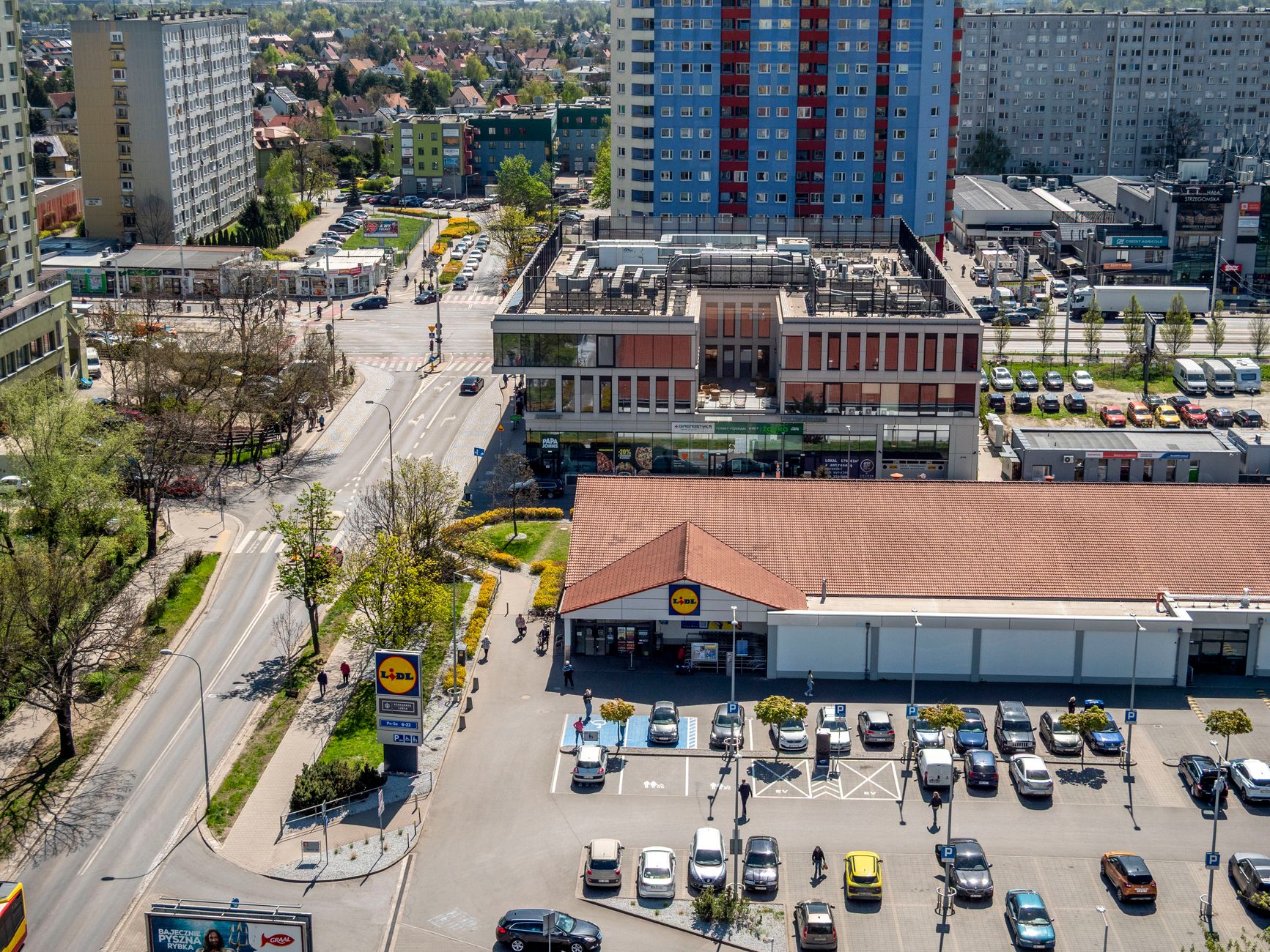 Aerial view of Wrocław's urban landscape highlighting a supermarket and streets.