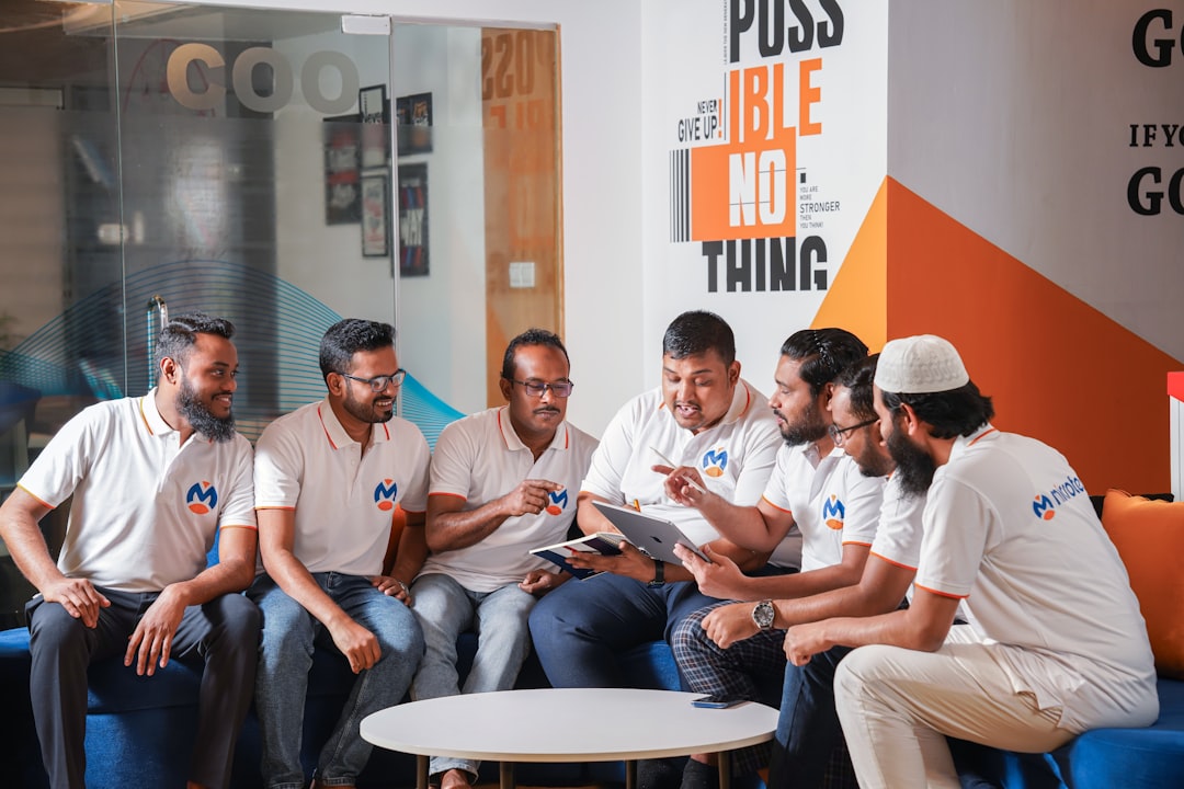 A group of men sitting around each other